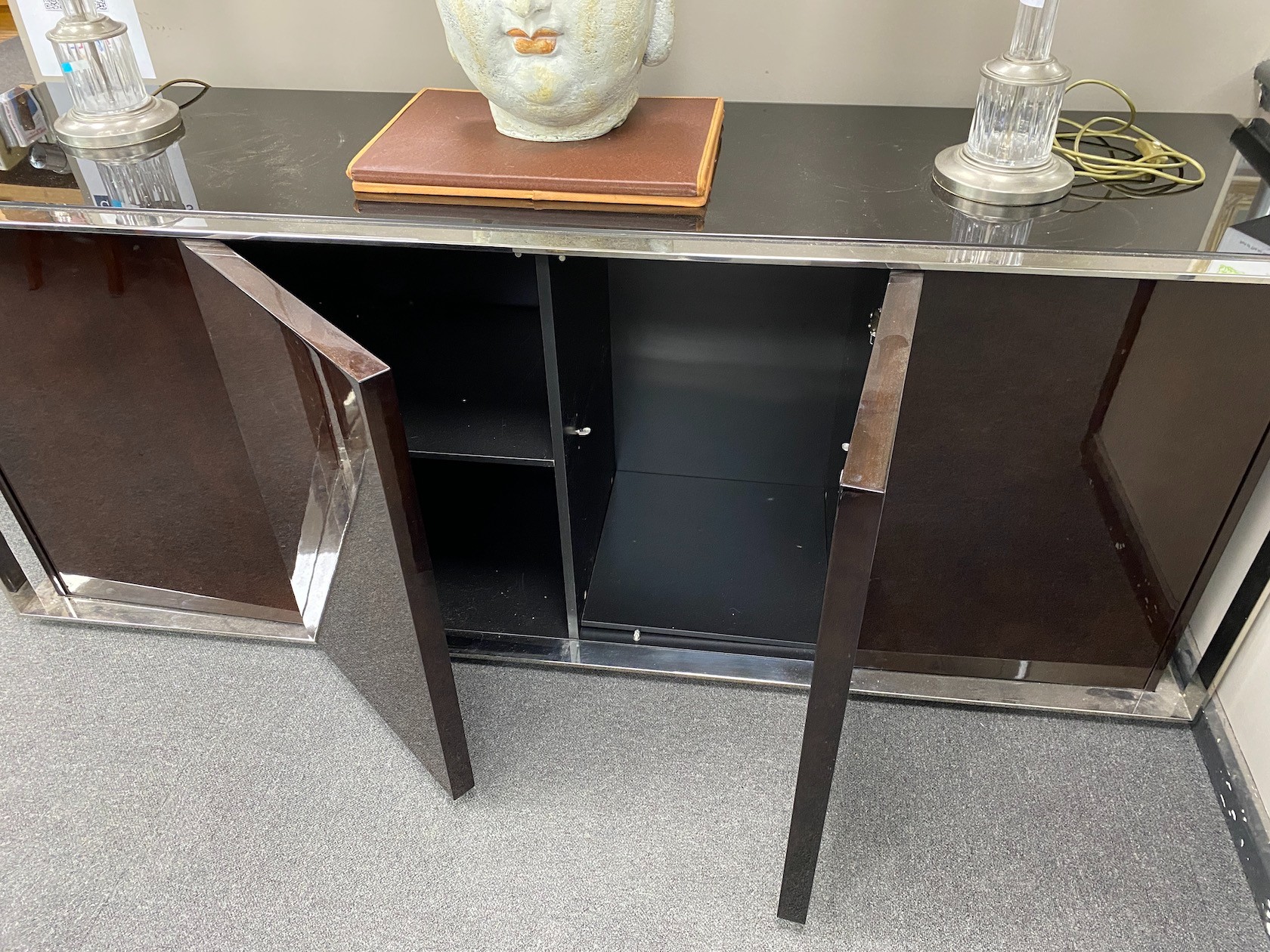 A pair of contemporary chrome and black glass side cabinets, length 200cm, depth 52cm, height 80cm